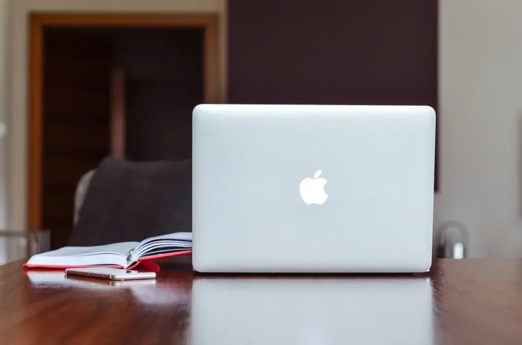 Laptop on a desk with WordPress backup plugin interface open
